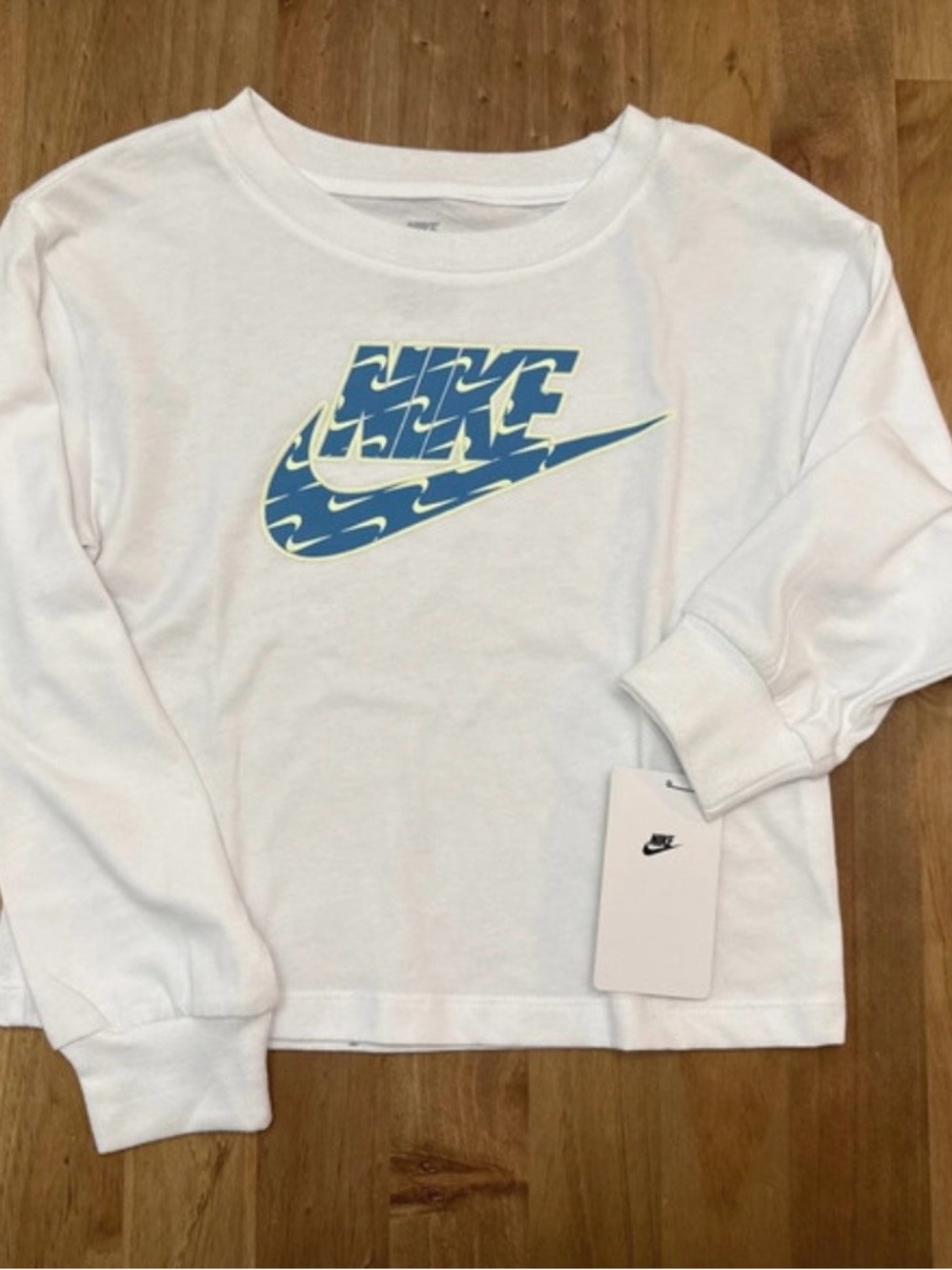 Nike White Long Sleeve Girl’s Tee with Blue Wave Logo